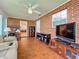 Spacious sunroom with brick walls, tiled floors, and built-in shelving at 1559 Lakeshore Dr, Eustis, FL 32726