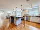 Open concept kitchen with large island, hardwood floors, and views to Gathering and dining rooms at 1559 Lakeshore Dr, Eustis, FL 32726
