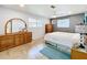 Spacious bedroom with a queen bed, dresser, and tiled floors at 1559 Lakeshore Dr, Eustis, FL 32726