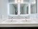 Updated bathroom with double vanity and modern light fixtures at 1559 Lakeshore Dr, Eustis, FL 32726