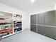 Garage with storage shelves, cabinets, and extra space at 1559 Lakeshore Dr, Eustis, FL 32726