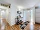 Bright and airy entryway with wood floors and decorative console table at 1559 Lakeshore Dr, Eustis, FL 32726