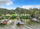 Lakefront property with multiple docks and lush vegetation at 1559 Lakeshore Dr, Eustis, FL 32726