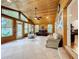 Relaxing sunroom with wood ceiling, tile floors, and water views at 1559 Lakeshore Dr, Eustis, FL 32726