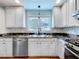 Modern kitchen with white cabinets, granite countertops, and tile backsplash at 1559 Lakeshore Dr, Eustis, FL 32726