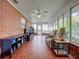 Bright sunroom features tile flooring, brick walls, and ample seating at 1559 Lakeshore Dr, Eustis, FL 32726