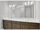 Double vanity bathroom with a large mirror and modern fixtures at 3018 Mirage Pl, Saint Cloud, FL 34771