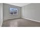 Spacious bedroom with grey walls and wood-look tile flooring at 3018 Mirage Pl, Saint Cloud, FL 34771