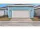 Detached garage with white door and light blue exterior at 3018 Mirage Pl, St Cloud, FL 34771