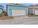 Detached garage with white door and light blue exterior at 3018 Mirage Pl, Saint Cloud, FL 34771