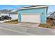 Detached garage with white door and light blue exterior at 3018 Mirage Pl, St Cloud, FL 34771