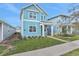 Two-story light blue home with green door and walkway at 3018 Mirage Pl, St Cloud, FL 34771