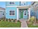 Front entry of light blue home with green door and walkway at 3018 Mirage Pl, Saint Cloud, FL 34771