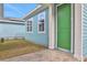 Green door and light blue exterior walls with small side yard at 3018 Mirage Pl, St Cloud, FL 34771