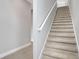Modern carpeted staircase with white railing at 3018 Mirage Pl, St Cloud, FL 34771
