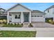 Exterior view of a light blue single story home with a light teal front door and brick paver driveway at 3108 Expedition Dr, Saint Cloud, FL 34771