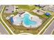 Aerial view of community pool with surrounding lounge areas and playground at 656 Daring Dr, Davenport, FL 33837
