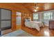 Cozy bedroom with wood floors and wood-paneled walls at 7373 Circle Dr, Lady Lake, FL 32159