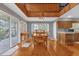 Bright dining room features hardwood floors, a wooden table with chairs, and access to a deck at 7373 Circle Dr, Lady Lake, FL 32159