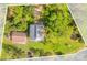 Aerial view of house and detached garage with a waterfront lot at 7373 Circle Dr, Lady Lake, FL 32159