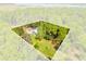 Aerial view of home and detached garage on a large waterfront lot at 7373 Circle Dr, Lady Lake, FL 32159