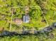 Aerial view showing a house and detached garage on a wooded lot at 7373 Circle Dr, Lady Lake, FL 32159