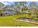 Two-story home with a spacious backyard, dock, and pond at 7373 Circle Dr, Lady Lake, FL 32159
