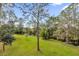 Landscaped backyard with tranquil water view at 7373 Circle Dr, Lady Lake, FL 32159