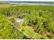 Aerial view of waterfront property with house and detached garage at 7373 Circle Dr, Lady Lake, FL 32159