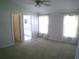 Main bedroom with carpet flooring, large windows and ensuite bathroom access at 8527 Firestone Cir, Clermont, FL 34711