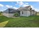 House exterior with screened enclosure and lush lawn at 4049 Nostalgia Ter, The Villages, FL 32163