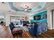 Open living room featuring a blue accent wall, hardwood floors, and comfortable seating at 4049 Nostalgia Ter, The Villages, FL 32163