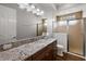 Bathroom with granite countertop and shower at 4049 Nostalgia Ter, The Villages, FL 32163