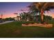 Landscaped yard with two-story home and palm trees at 4049 Nostalgia Ter, The Villages, FL 32163