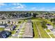 Aerial view showcasing townhouses, landscaping, and surrounding neighborhood at 1496 Mirabella Cir, Davenport, FL 33897