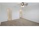 Carpeted bedroom with ceiling fan and en-suite bathroom access at 1496 Mirabella Cir, Davenport, FL 33897