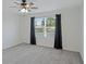 Spacious bedroom with ceiling fan, window with blinds and dark curtains at 1496 Mirabella Cir, Davenport, FL 33897