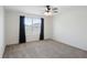 Bright bedroom with carpeted floor, ceiling fan, and large window at 1496 Mirabella Cir, Davenport, FL 33897