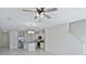 Open concept living room with kitchen and stairs views at 1496 Mirabella Cir, Davenport, FL 33897