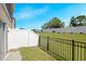 Private backyard with fenced patio and grassy area at 1496 Mirabella Cir, Davenport, FL 33897