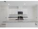White kitchen cabinets, granite countertops and stainless steel appliances at 1496 Mirabella Cir, Davenport, FL 33897