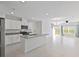 Open kitchen with island, stainless steel appliances, and white cabinets at 1496 Mirabella Cir, Davenport, FL 33897