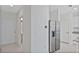Modern kitchen entry with stainless steel refrigerator and access to bathroom at 1496 Mirabella Cir, Davenport, FL 33897