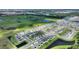 Aerial view of a new home community with houses, green spaces, and a lake at 656 Daring Dr, Davenport, FL 33837