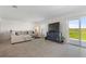 Spacious living room with comfortable seating and sliding glass doors leading to patio at 656 Daring Dr, Davenport, FL 33837