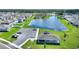 Aerial view showing community amenities including a playground, pavilion, parking and lake at 656 Daring Dr, Davenport, FL 33837