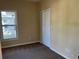 Well-lit bedroom featuring a closet and a window at 722 Mckenzie St, Leesburg, FL 34748