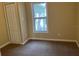 Bright bedroom with carpet flooring and a spacious closet at 722 Mckenzie St, Leesburg, FL 34748