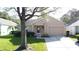 Single-story home with attached garage and lawn at 3661 Kingswood Ct, Clermont, FL 34711