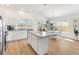 White kitchen with island, stainless steel appliances at 4353 Cameo Cir, The Villages, FL 32163